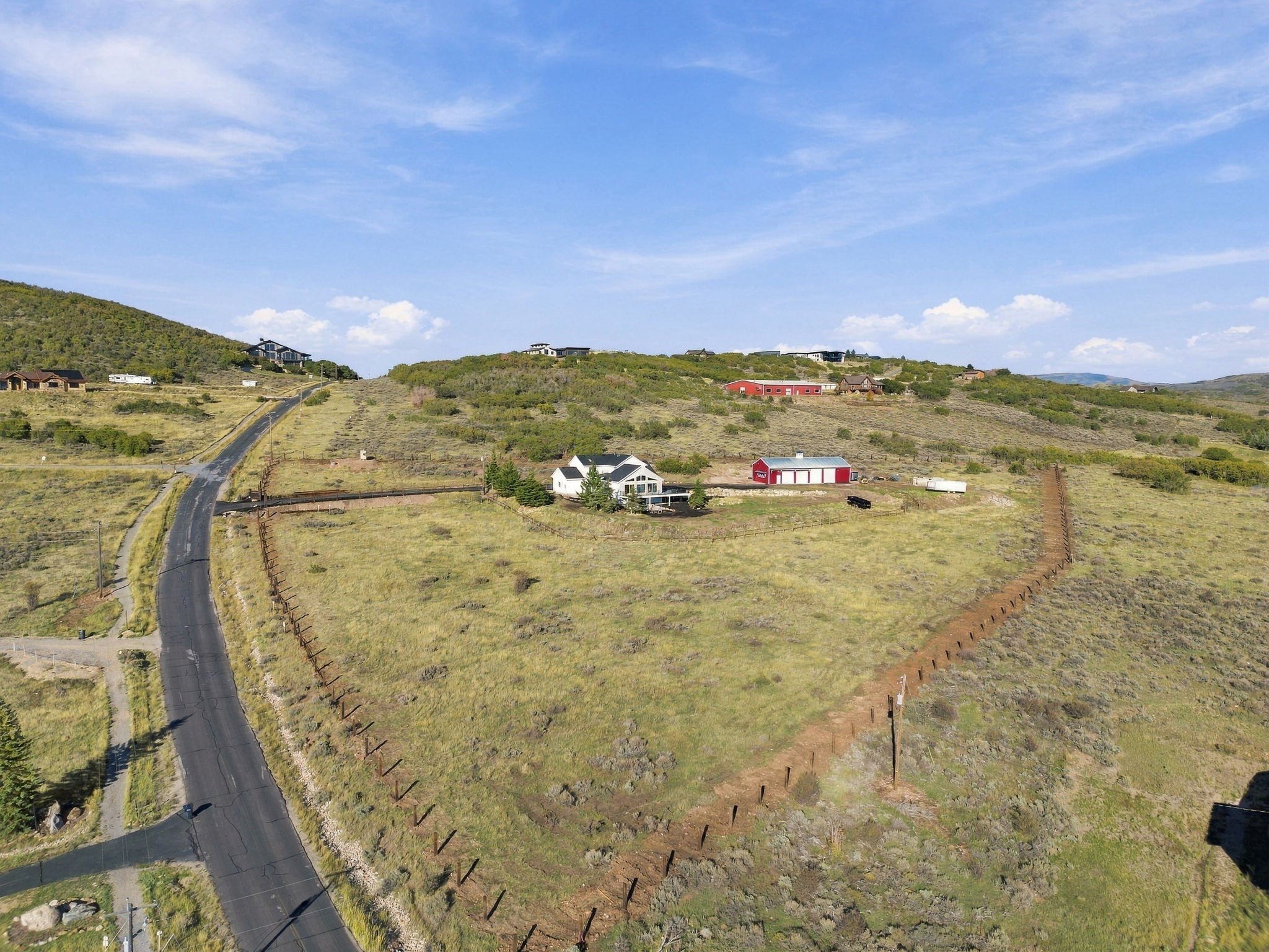 Aerial view of the drive, pasture, residence, and barn