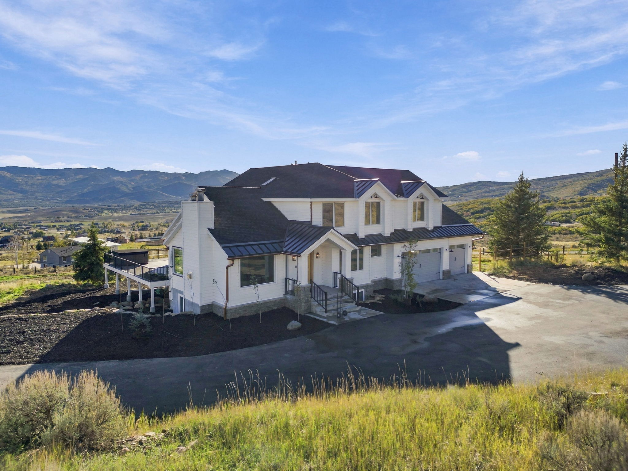 The residence and barn framed by the surrounding hillsides
