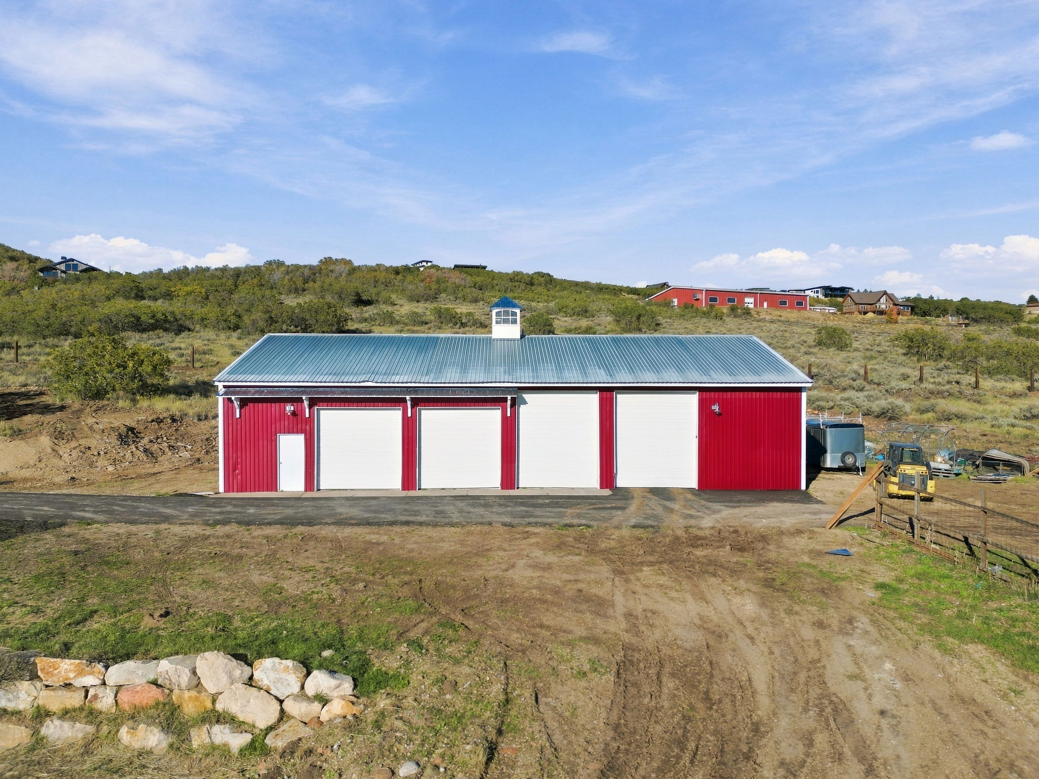 Aerial overview of the residence, barn, and surrounding land